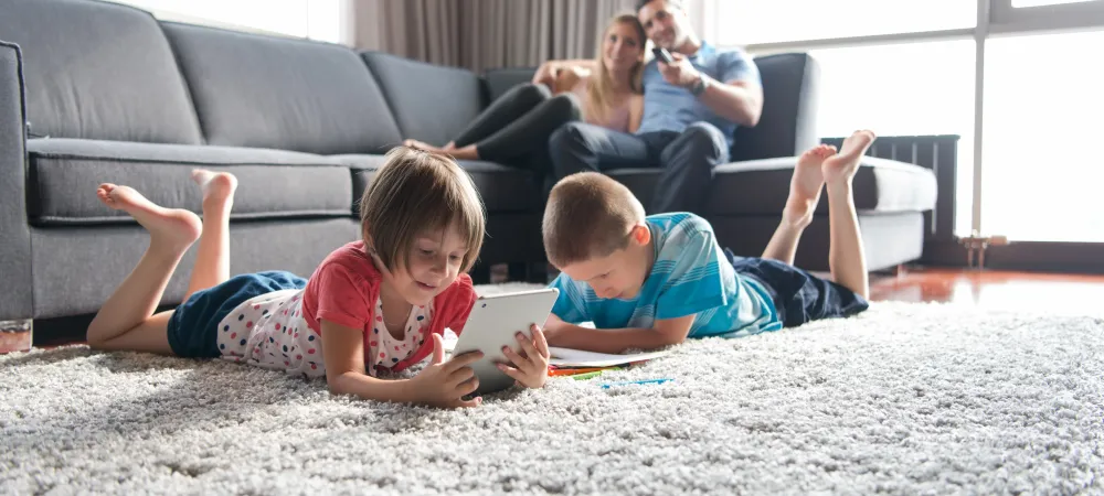 couple watching their kids play on the floor